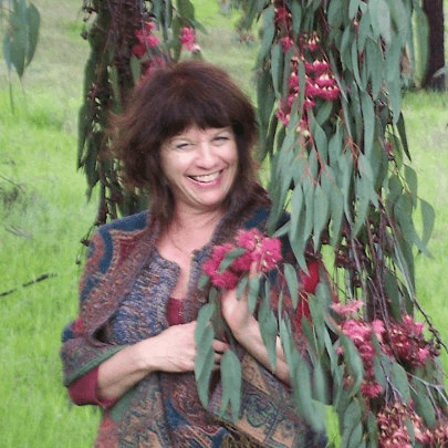 A smiling Judy Maier, owner of Judy’s gardens and designs, posing.