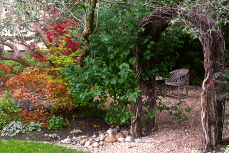 A secret garden with arch and furniture made from willow in Palo Alto