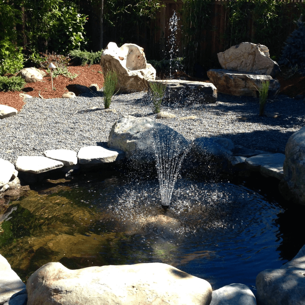 Stone furniture and a large garden room with pond in palo Alto, California